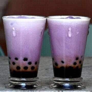 Two glasses with boba and taro milk tea