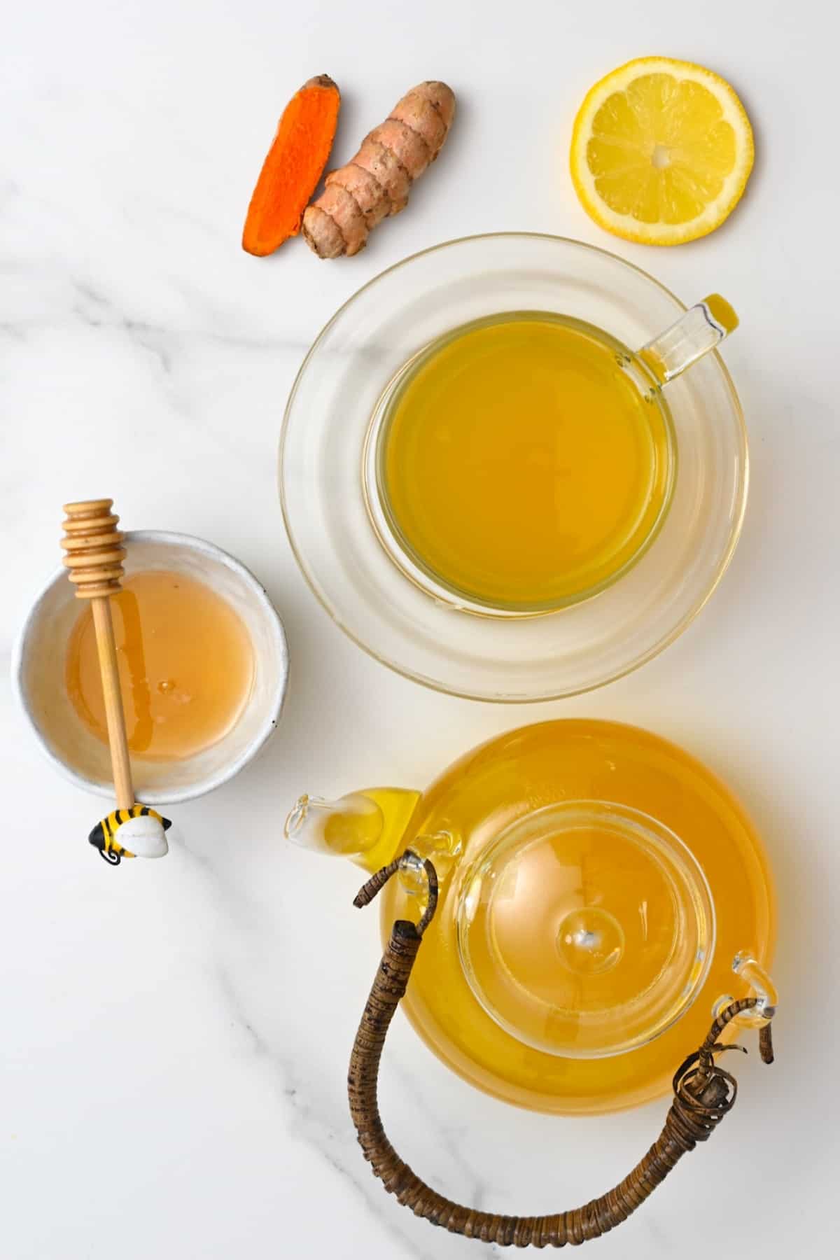 Turmeric tea in a cup and in a tea pot