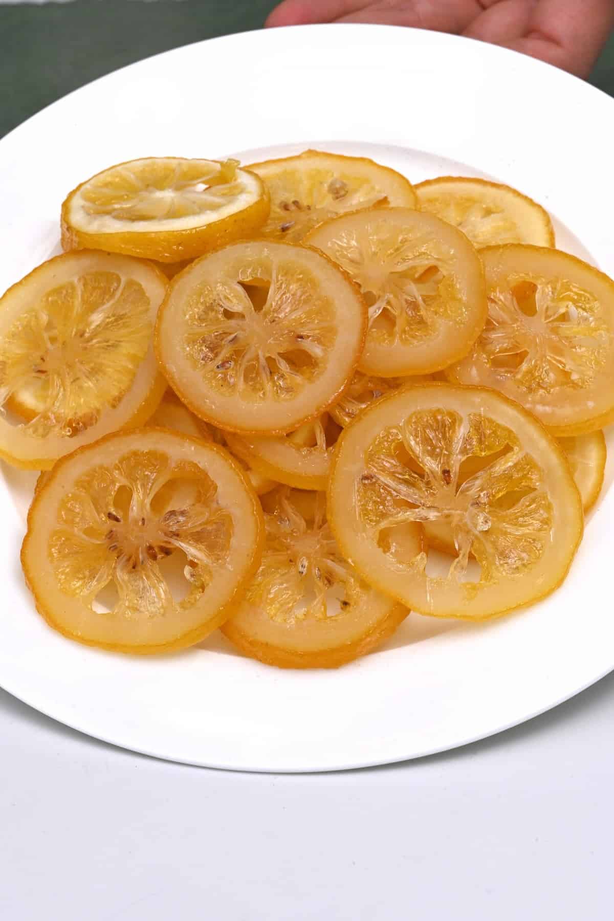 Candied lemon slices stacked on a plate