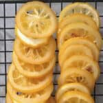 Homemade candied lemon slices arranged on a wire wrack
