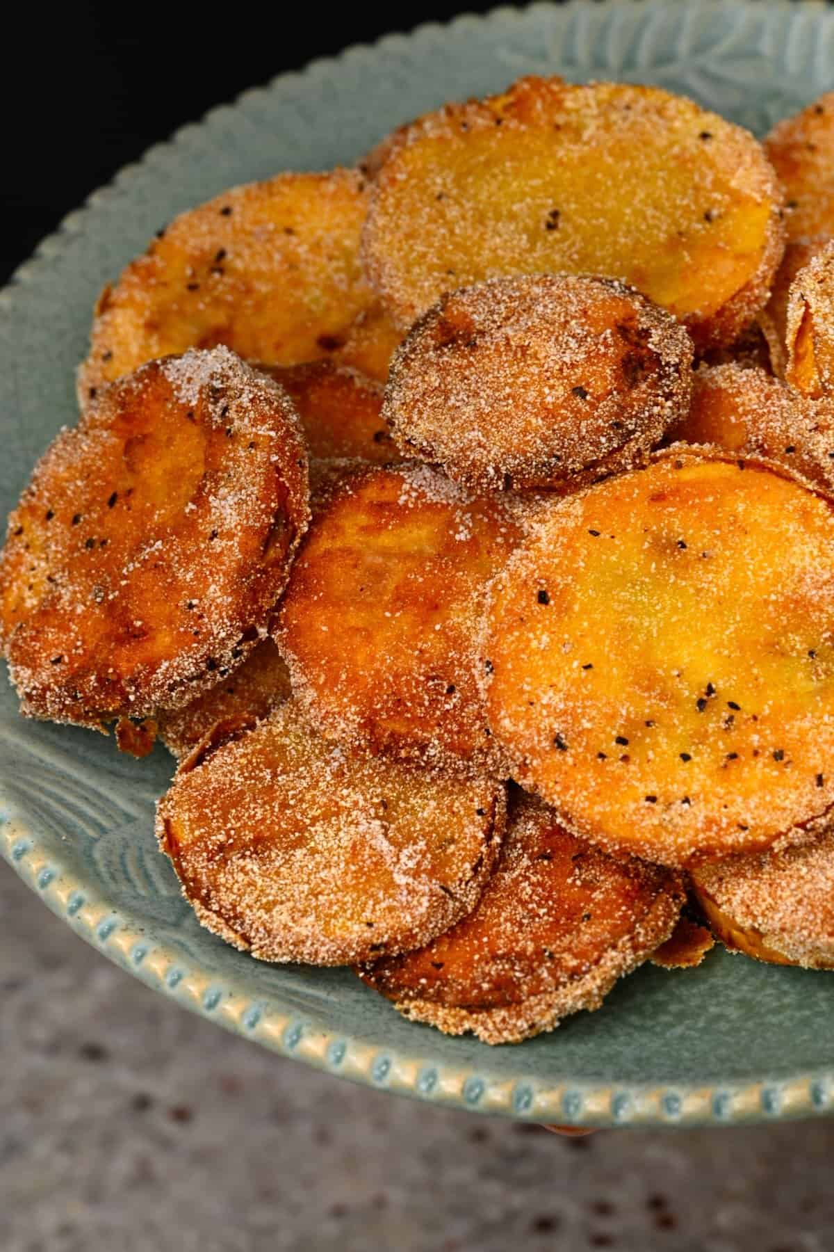 Freshly fried slices of yelloe squash on a plate