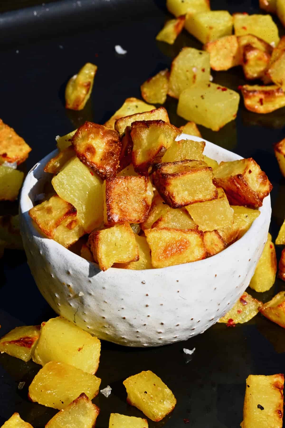 Oven fried potatoes in a small bowl