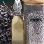 Lavender syrup in a bottle next to a jar with lavender petals - 13