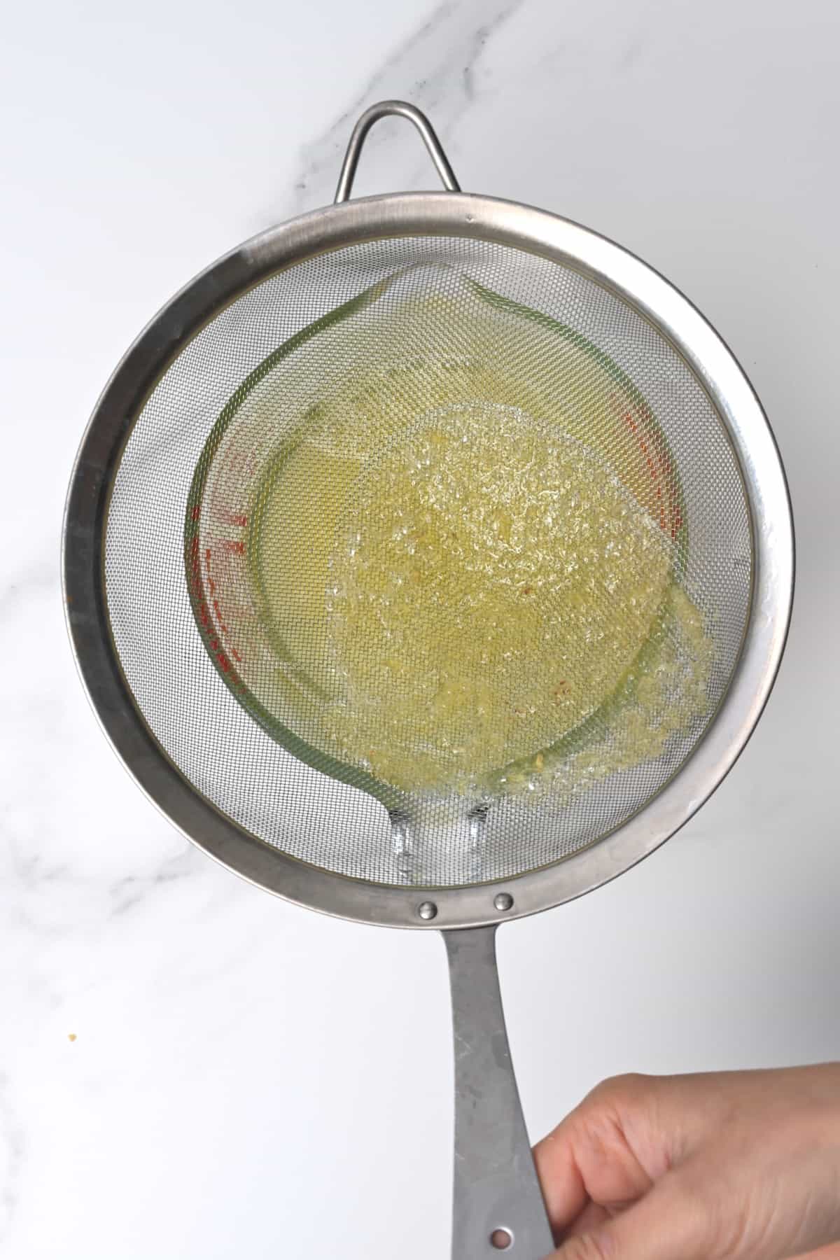 Sieving syrup to remove the lemon pulp
