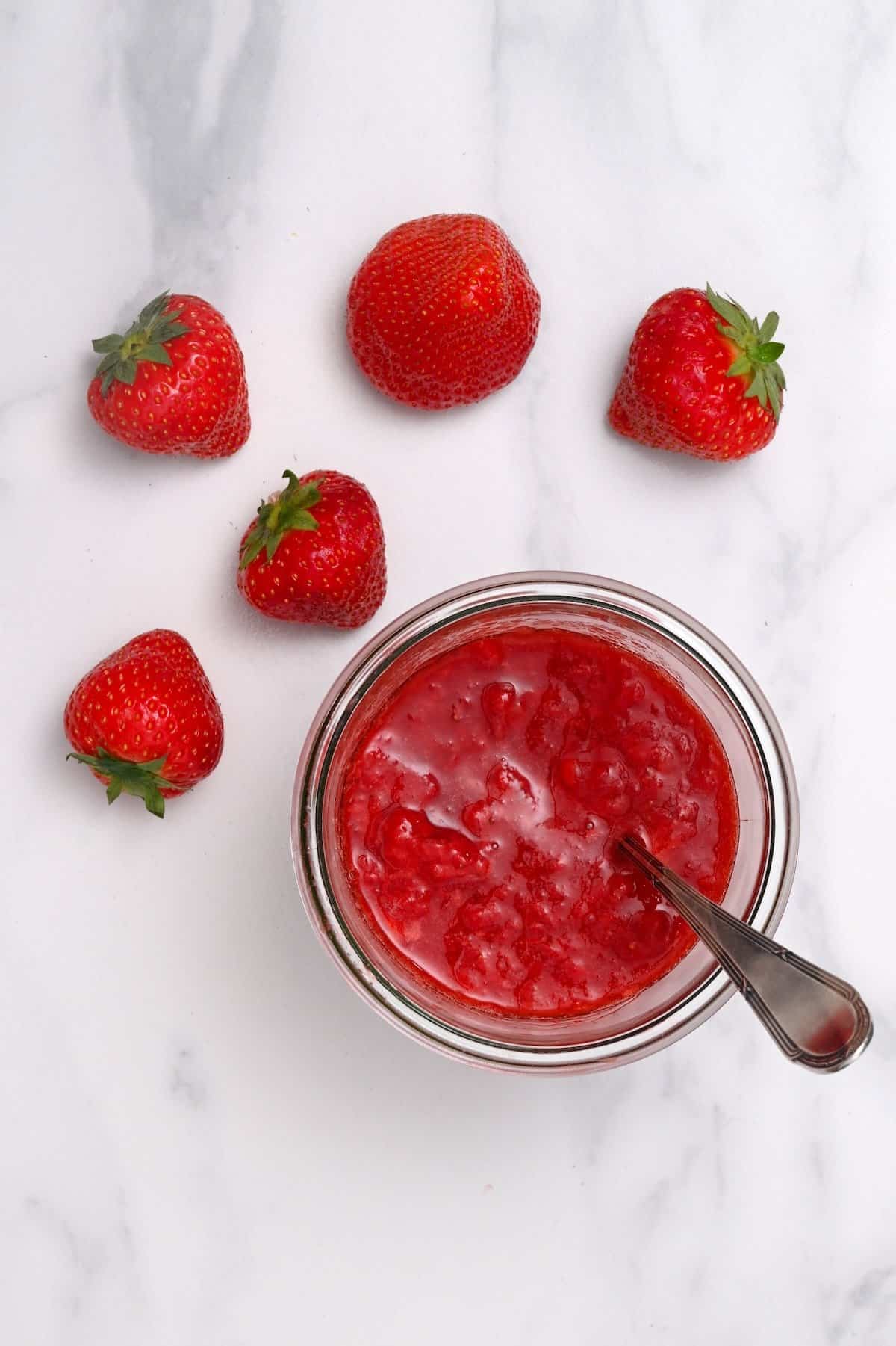Strawberries and a jar with compote
