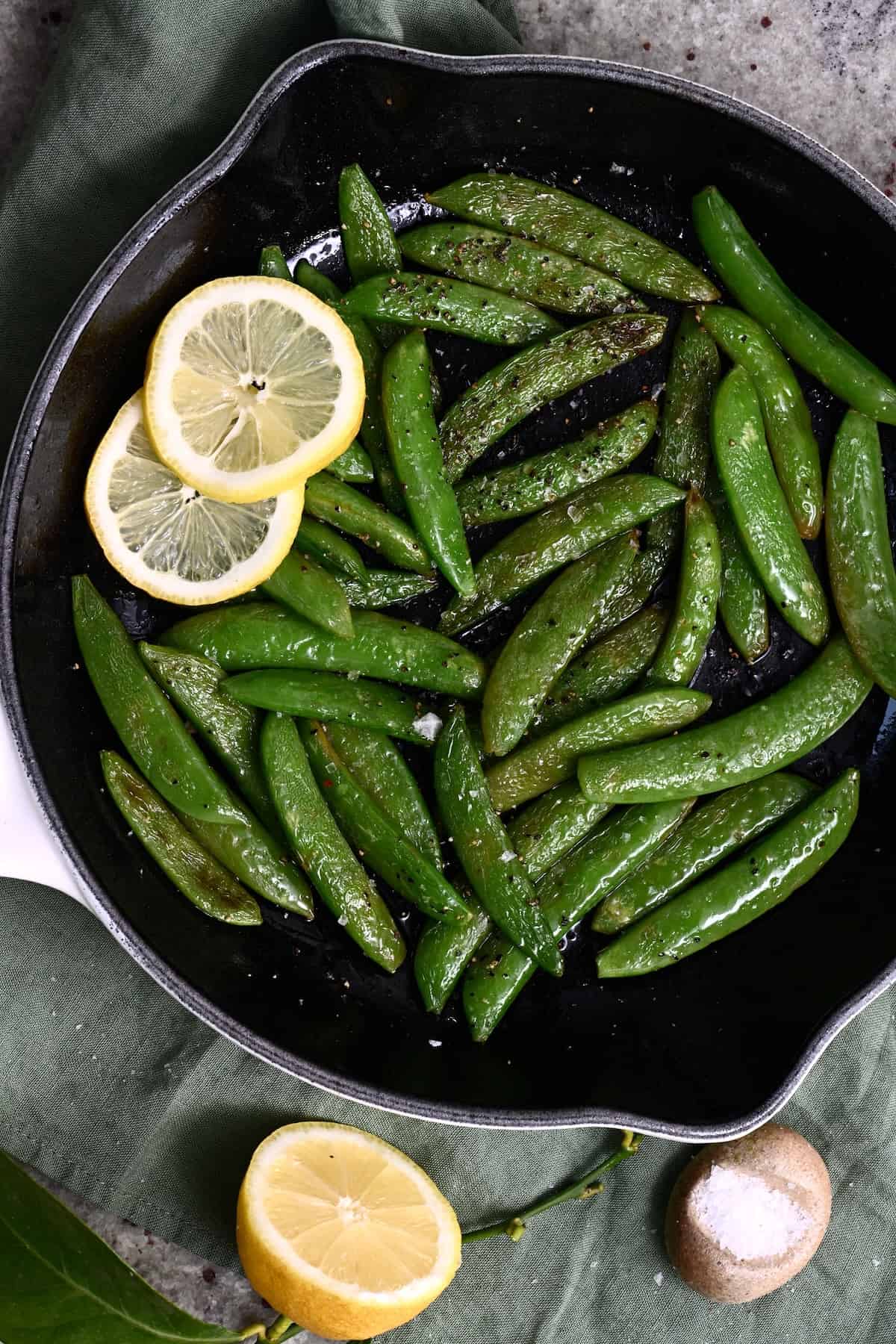 Fresly sauteed sugar snap peas in a pan
