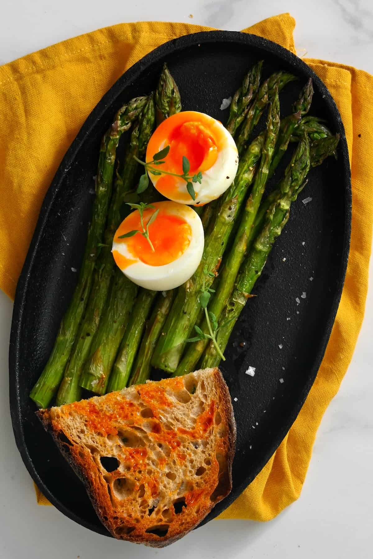 A toast and soft boiled egg and asparagus