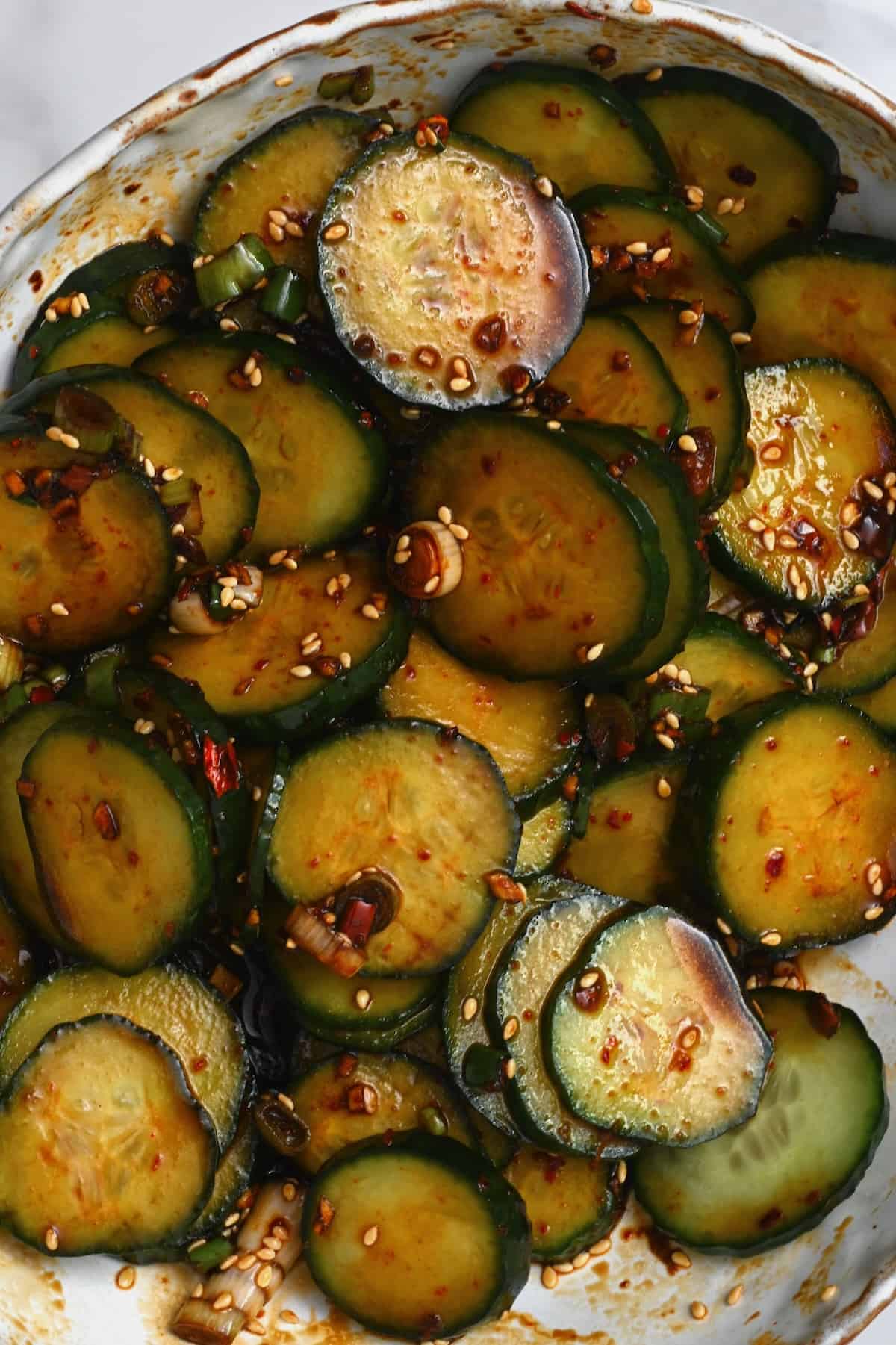 Close up of crunchy Asian cucumber salad topped with sesame seeds