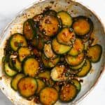 A bowl with crunchy Asian cucumber salad topped with sesame seeds - 8