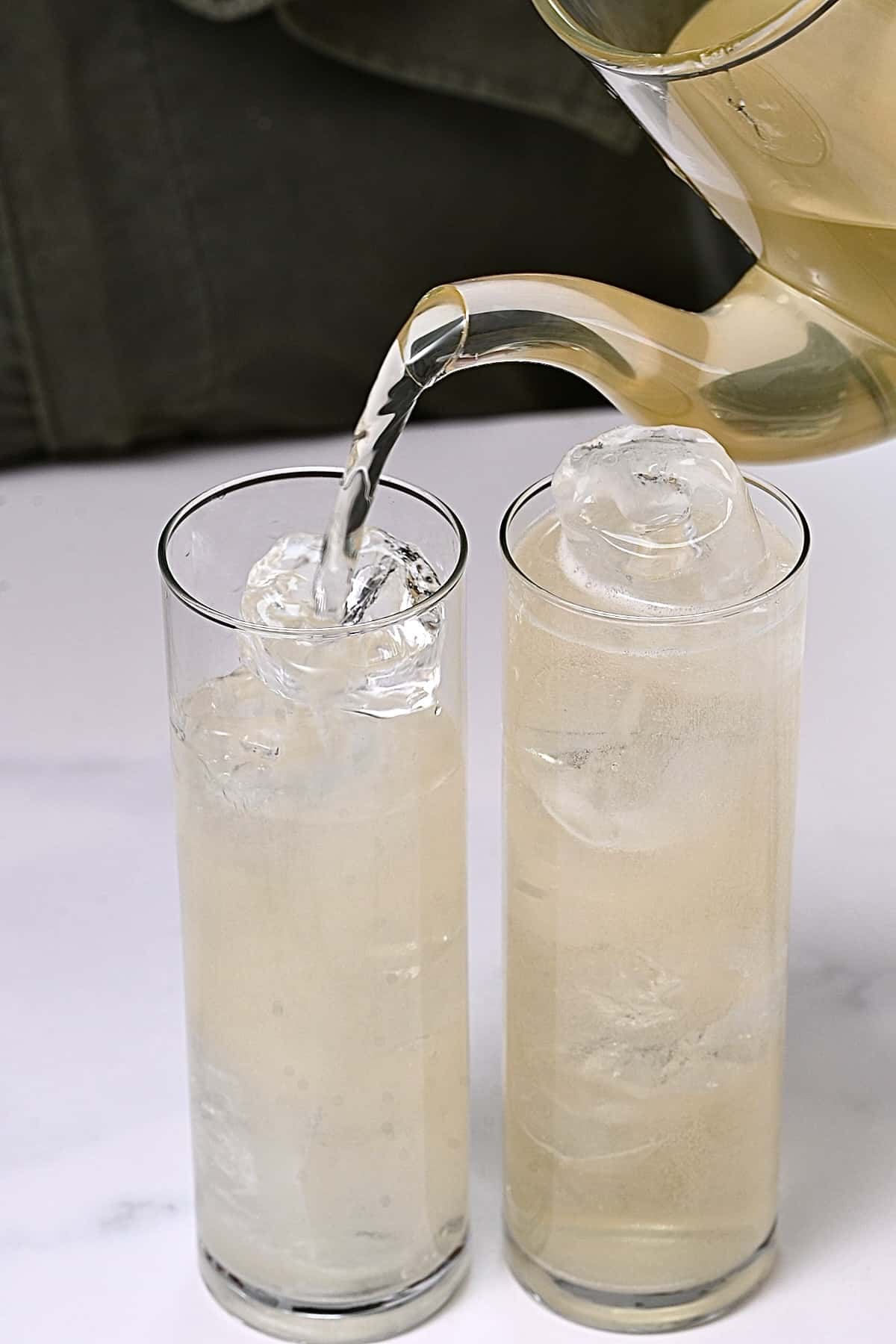 Pouring ginger ale in two glasses