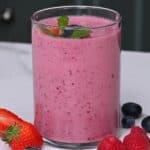 A glass with pink mixed berry smoothie