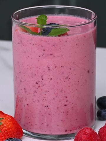 A glass with pink mixed berry smoothie