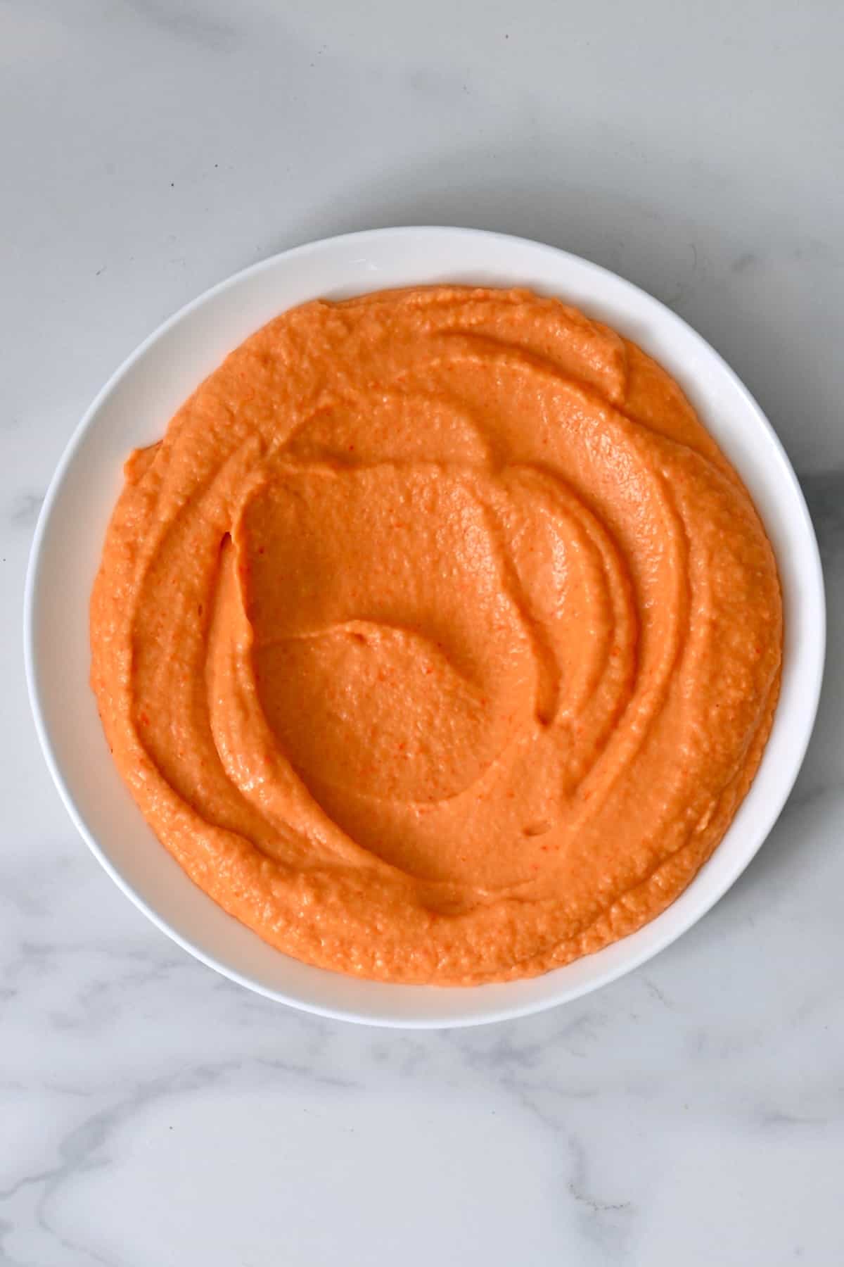 Roasted red pepper hummus on a plate