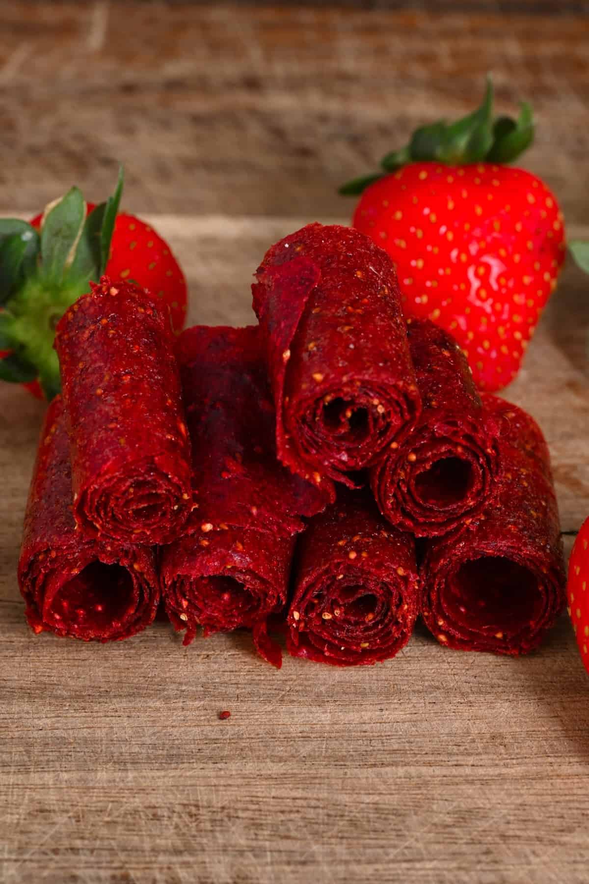 Strawberry fruit roll ups on a board