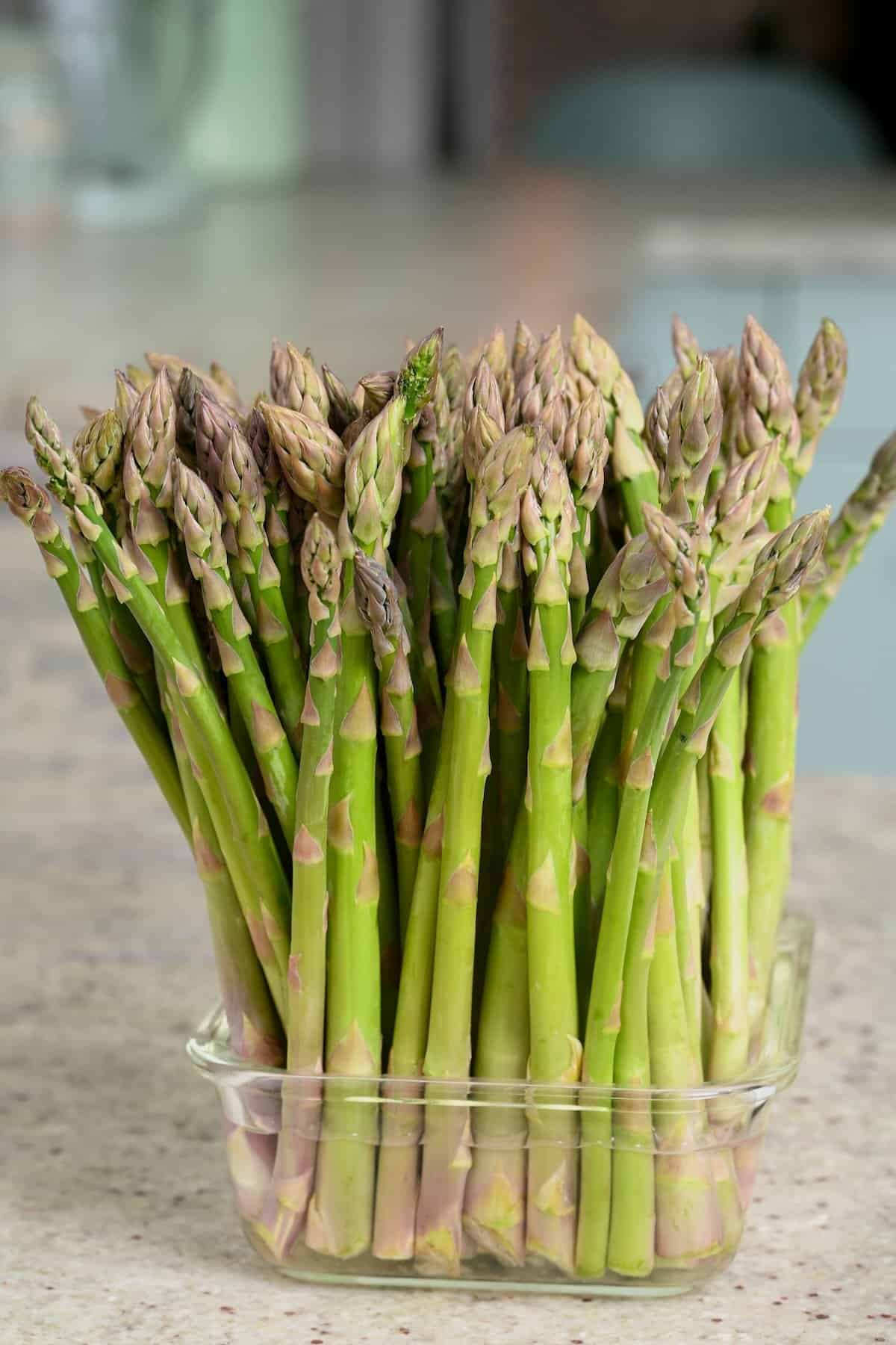 A bunch of asparagus in a container