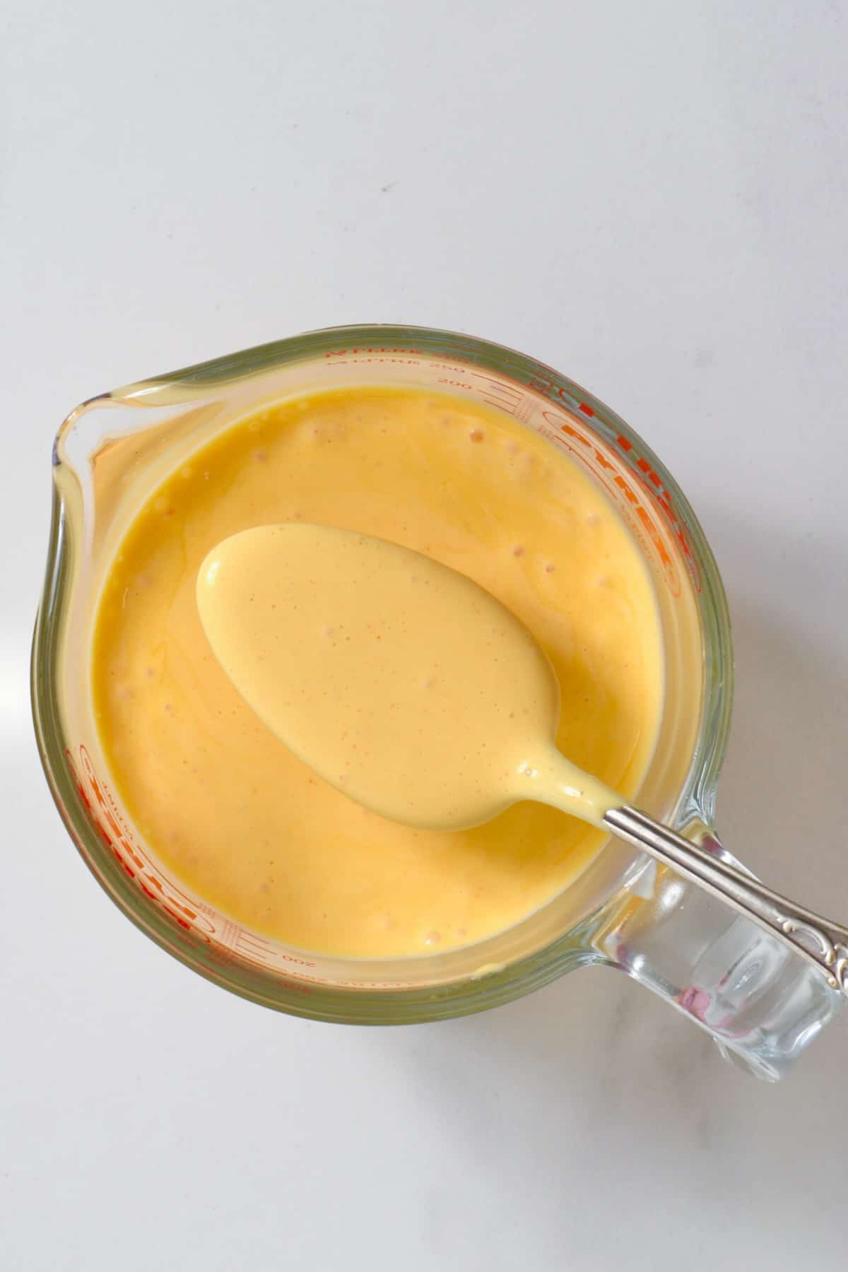 Hollandaise sauce in a measuring cup