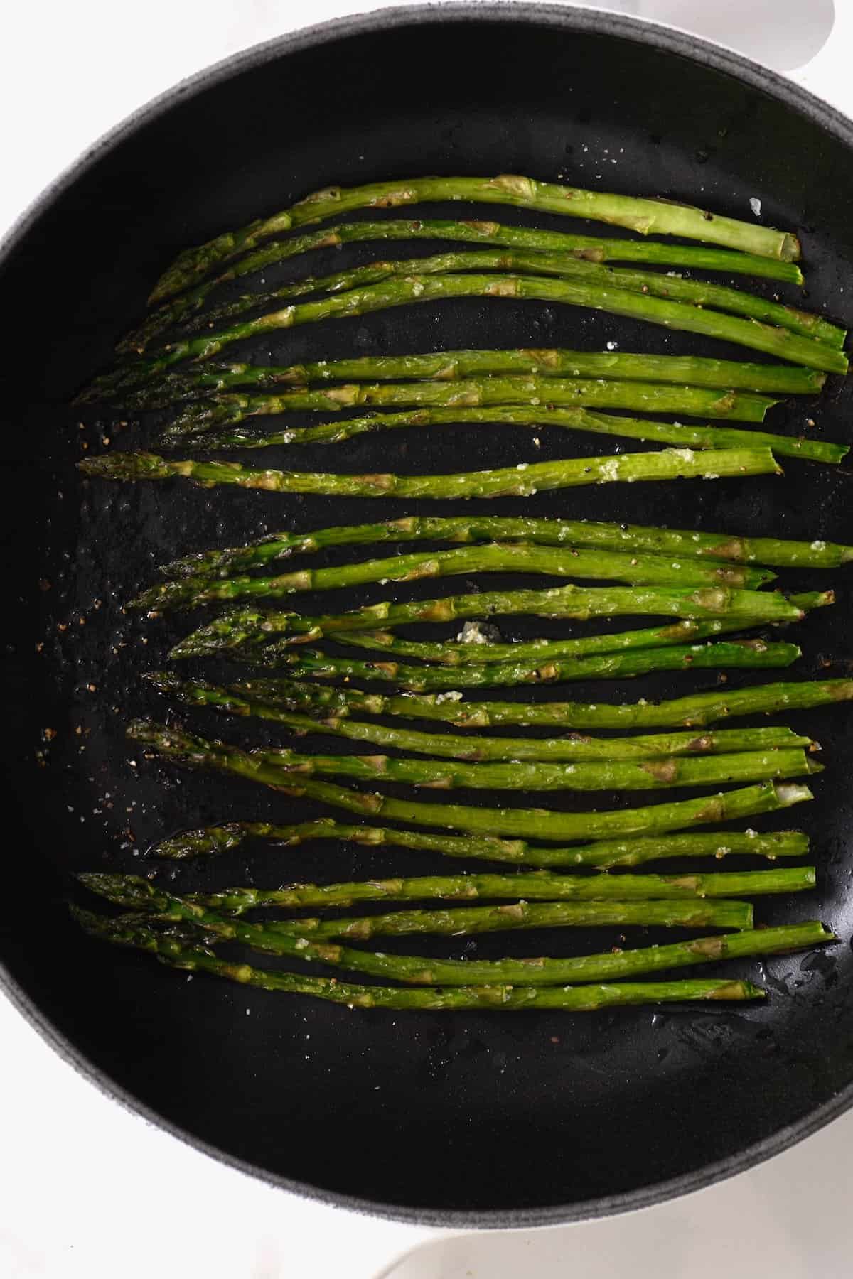 Oven roasted asparagus in a pan
