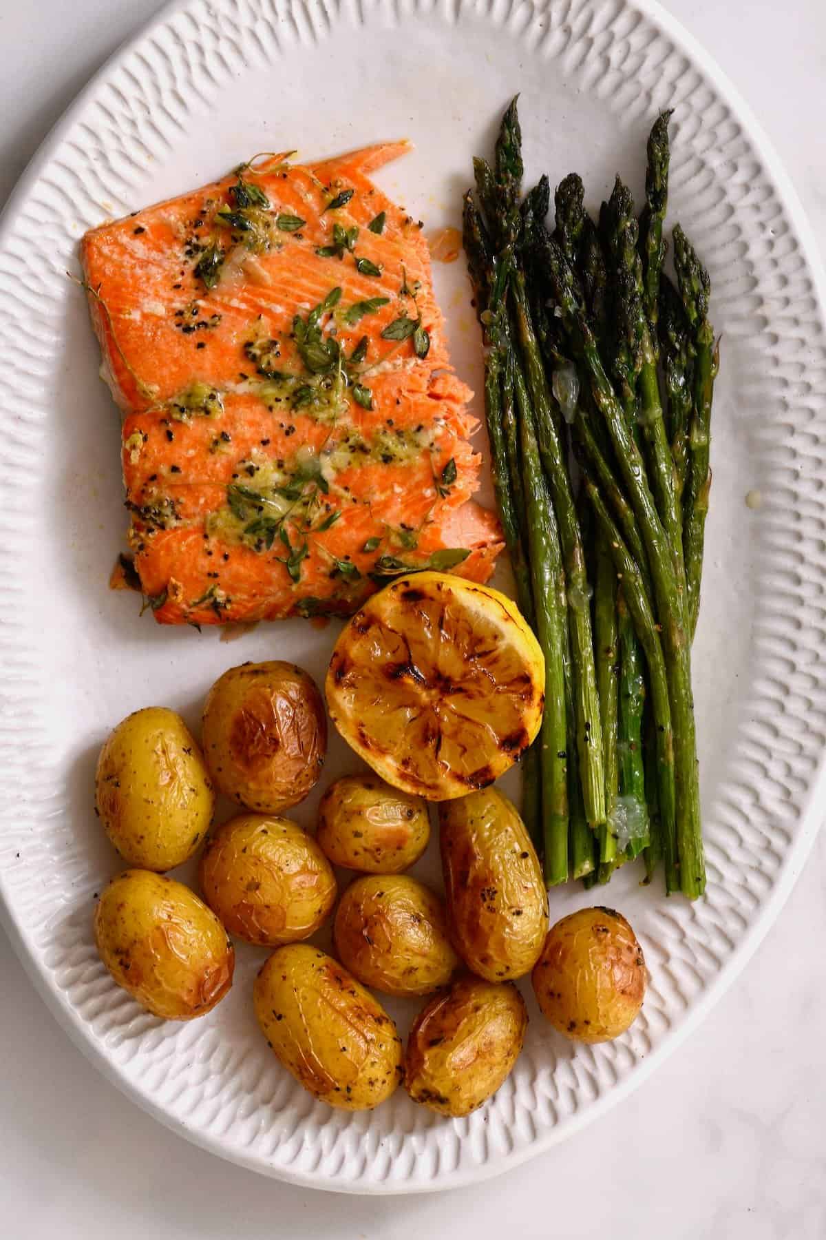Oven roasted asparagus served with salmon and potatoes