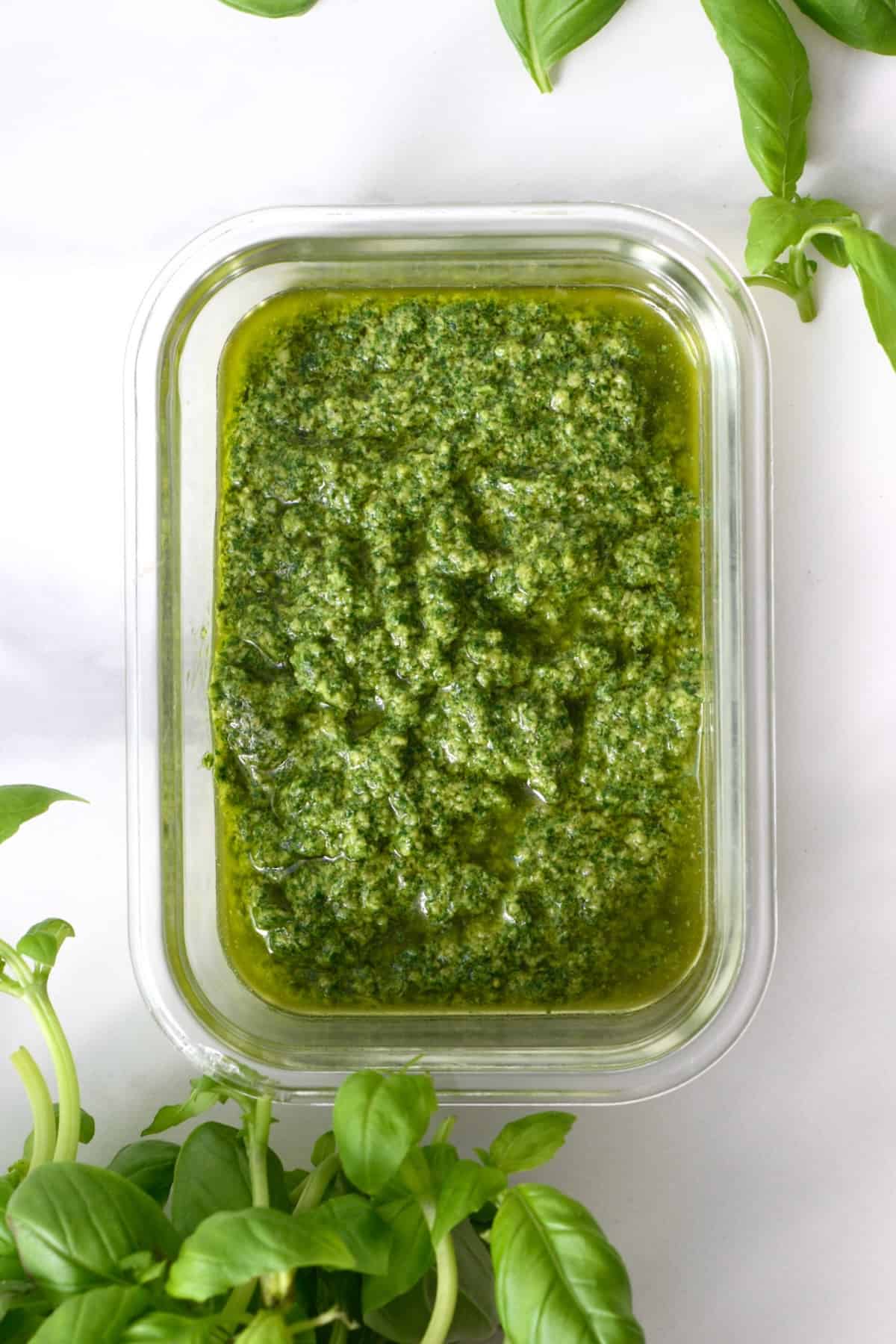Top view of a container with vegan basil pesto