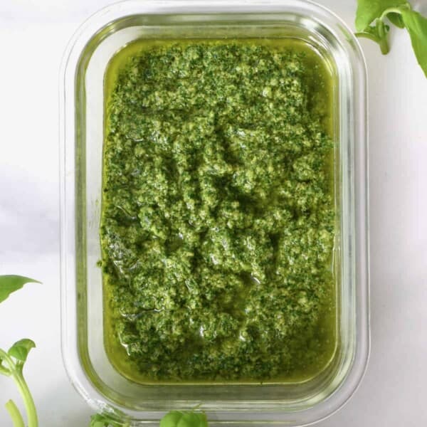 Top view of a container with vegan basil pesto
