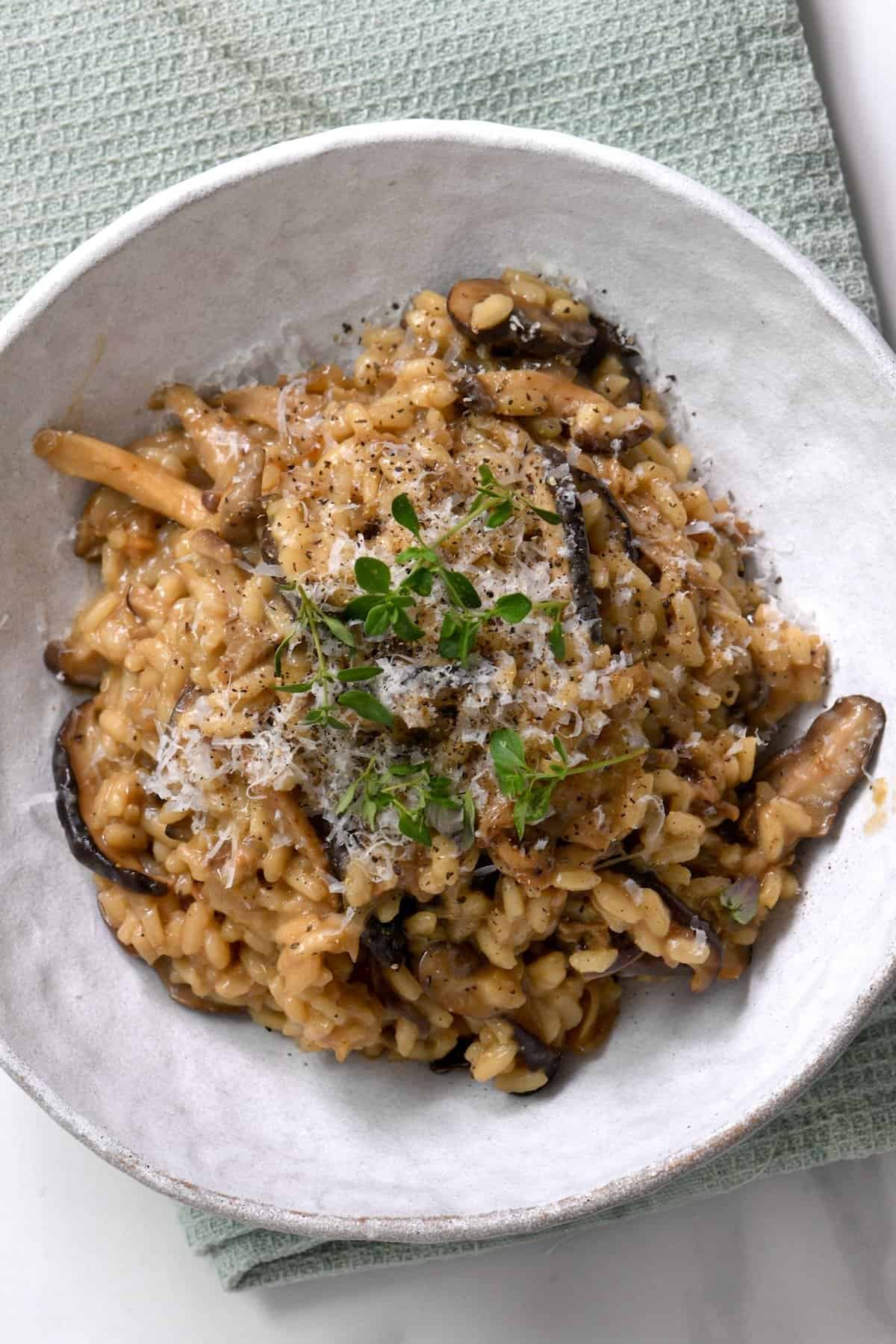 A serving of mushroom risotto topped with thyme