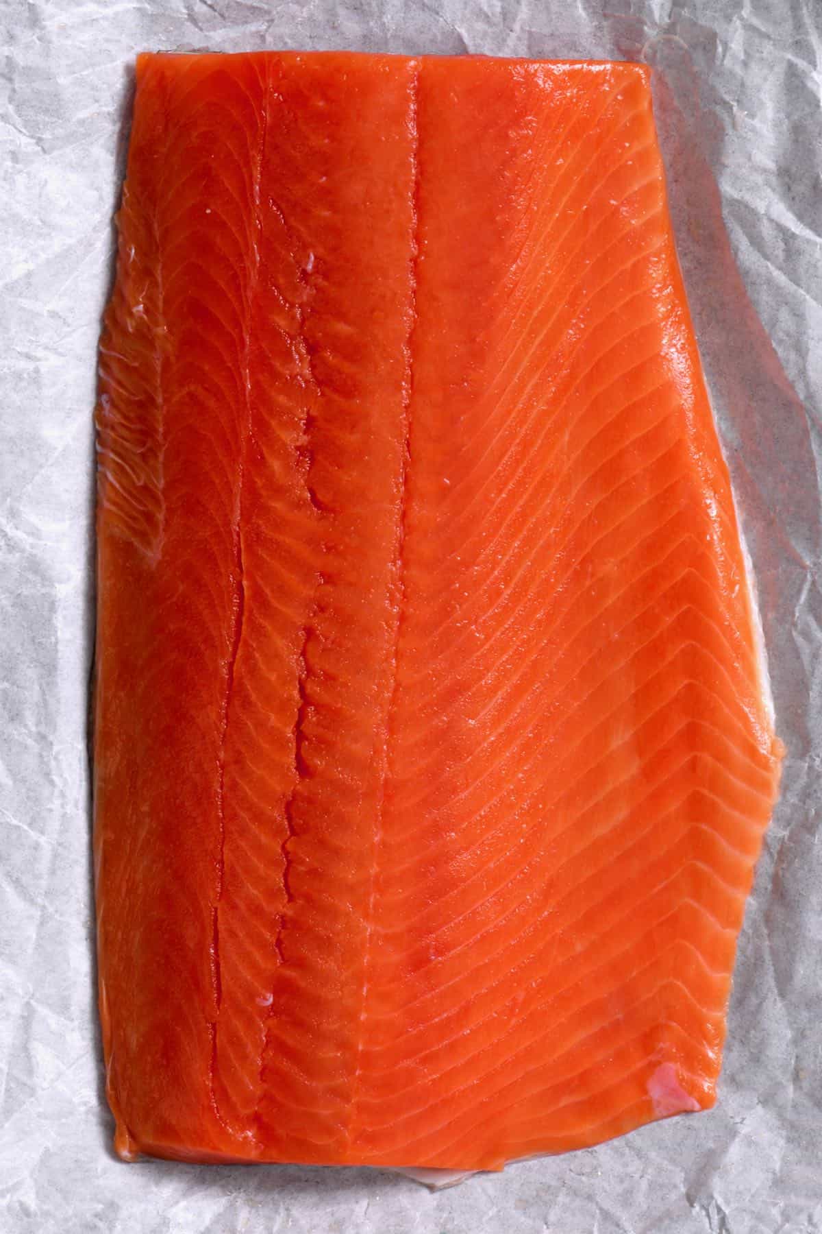 raw wild salmon on a baking sheet