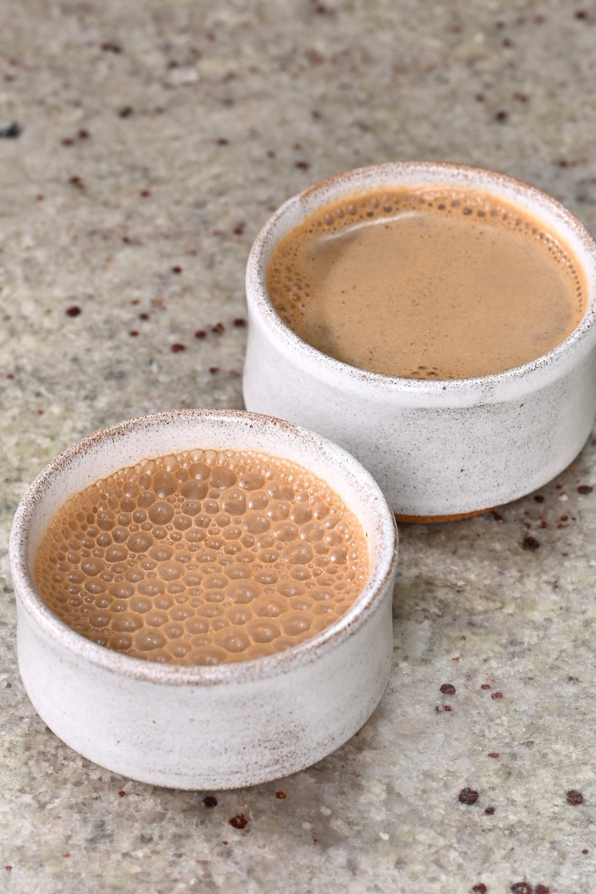 Two small cups with bulletproof foamy coffee