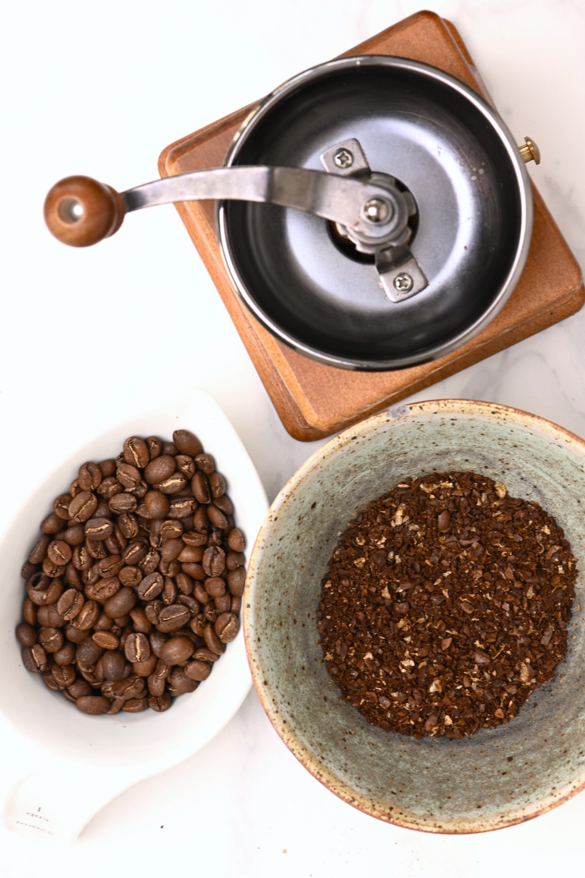 Coffee beans and coarsely ground coffee in a bowl