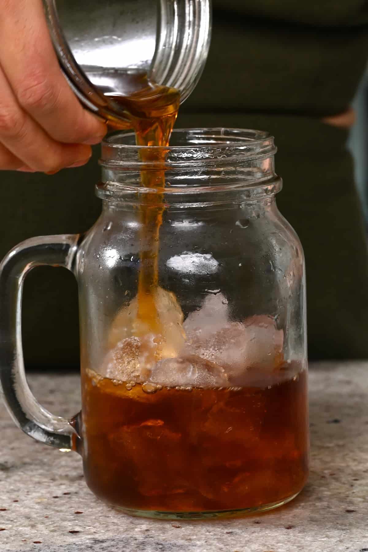 Pouring cold brew coffee over ice