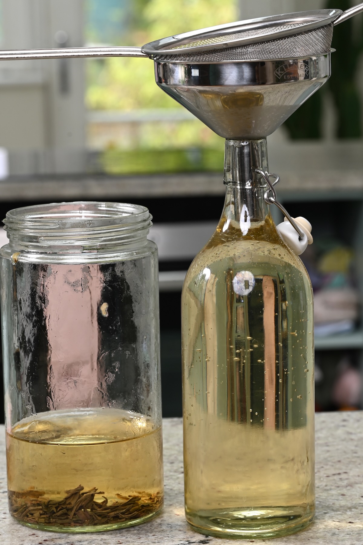 Sieving cold brew tea in a bottle
