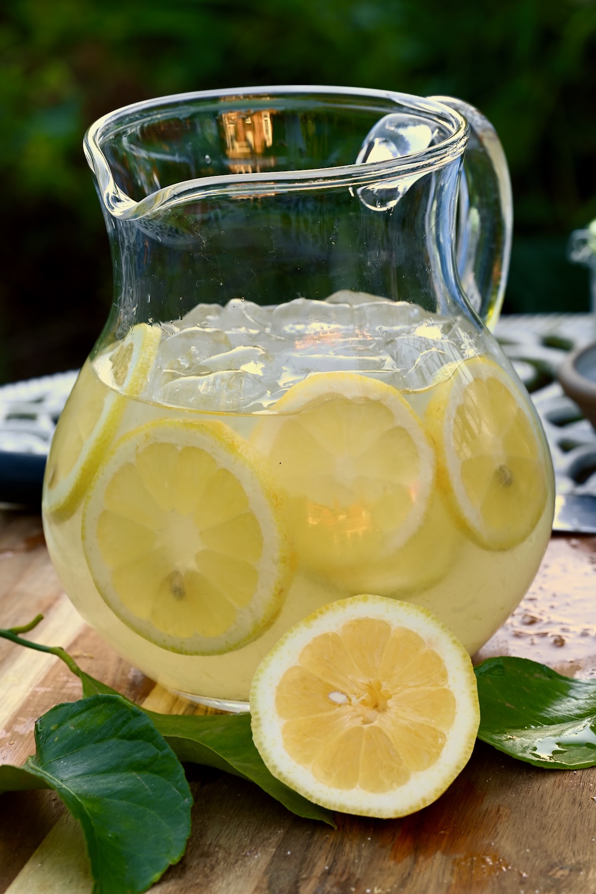 A jug with lemon slices and homemade lemonade