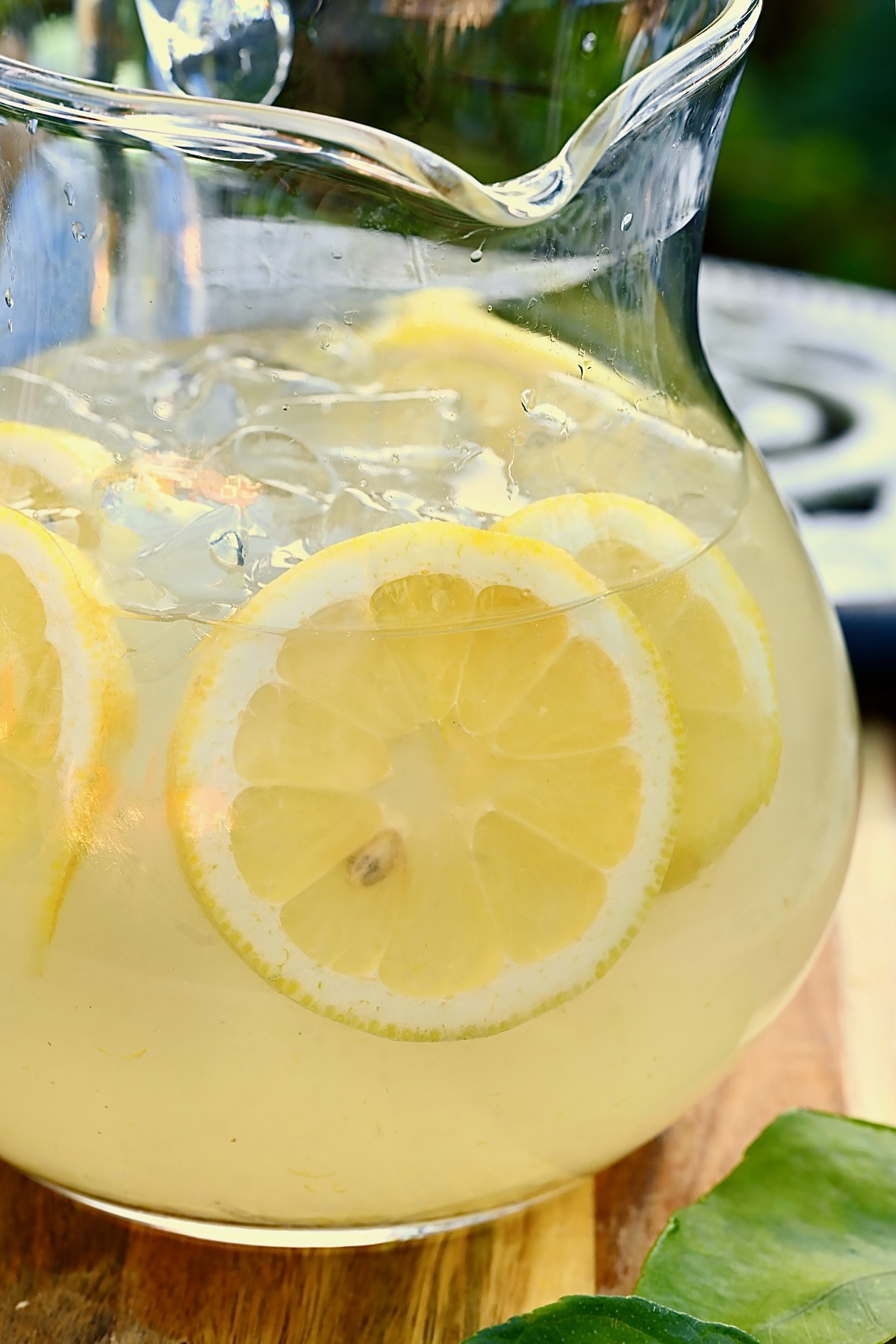 A pitcher with homemade lemonade and slices of lemon