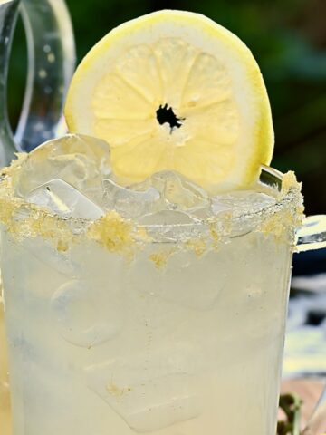 A glass with homemade lemonade and a slice of lemon