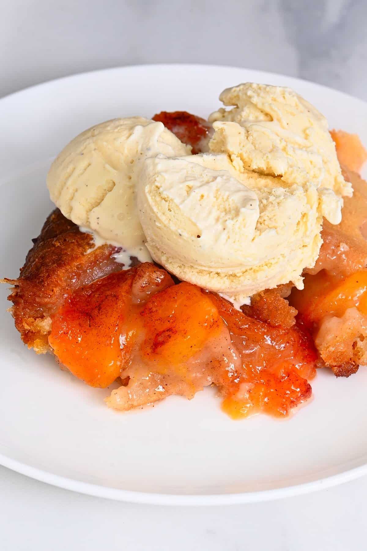 A serving of peach cobbler and ice cream