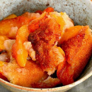 A seeing of peach cobbler in a bowl