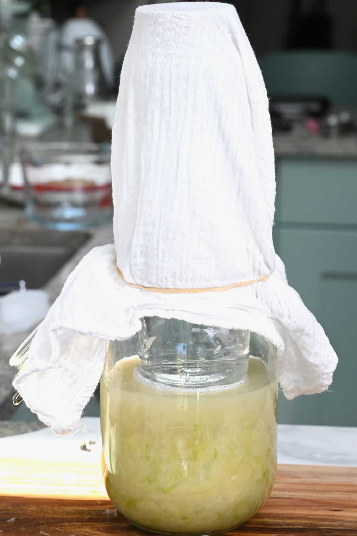 Making sauerkraut in a jar covered with towel