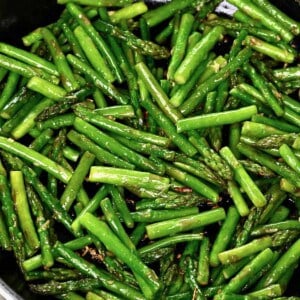 Sautéed asparagus in a large pan