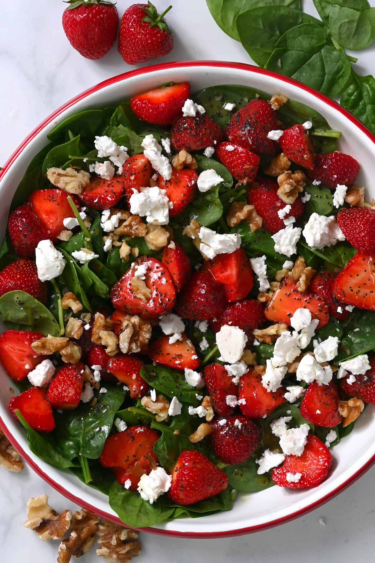 Strawberry spinach salad topped with feta and walnuts