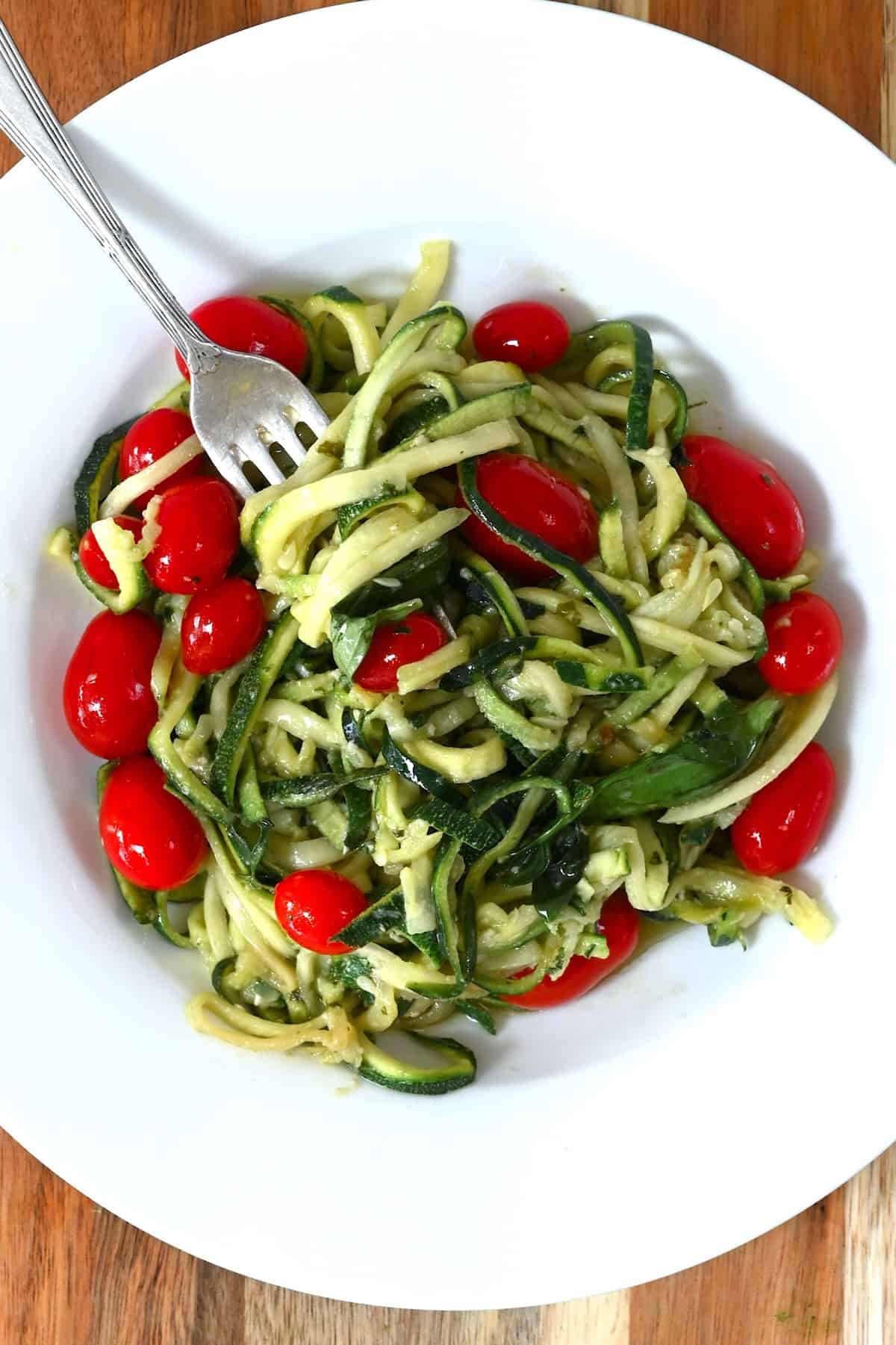 A serving of zucchini noodles with cherry tomatoes