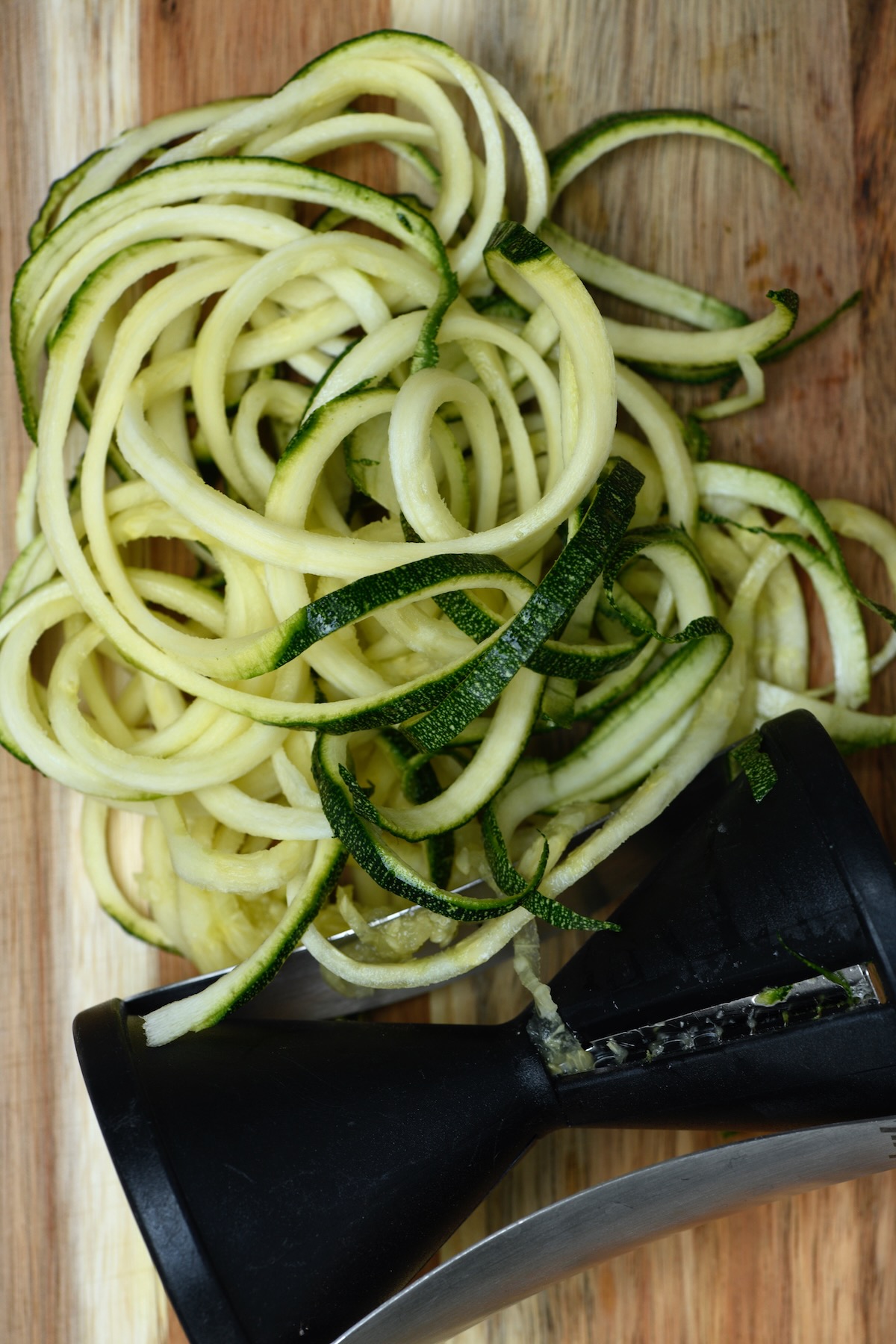 Making zoodles with a hand-held zoodler