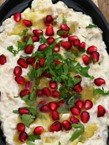 Homemade baba ghanoush topped with pomegranate seeds and parsley
