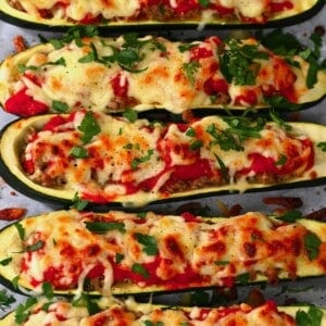 Stuffed zucchini topped with cheese and parsley