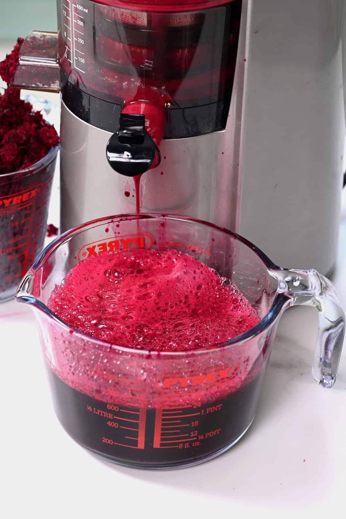 Juicing beetroot with a juicer