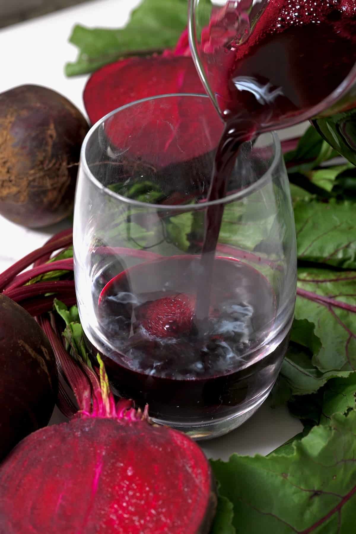 Pouring beet juice in a glass
