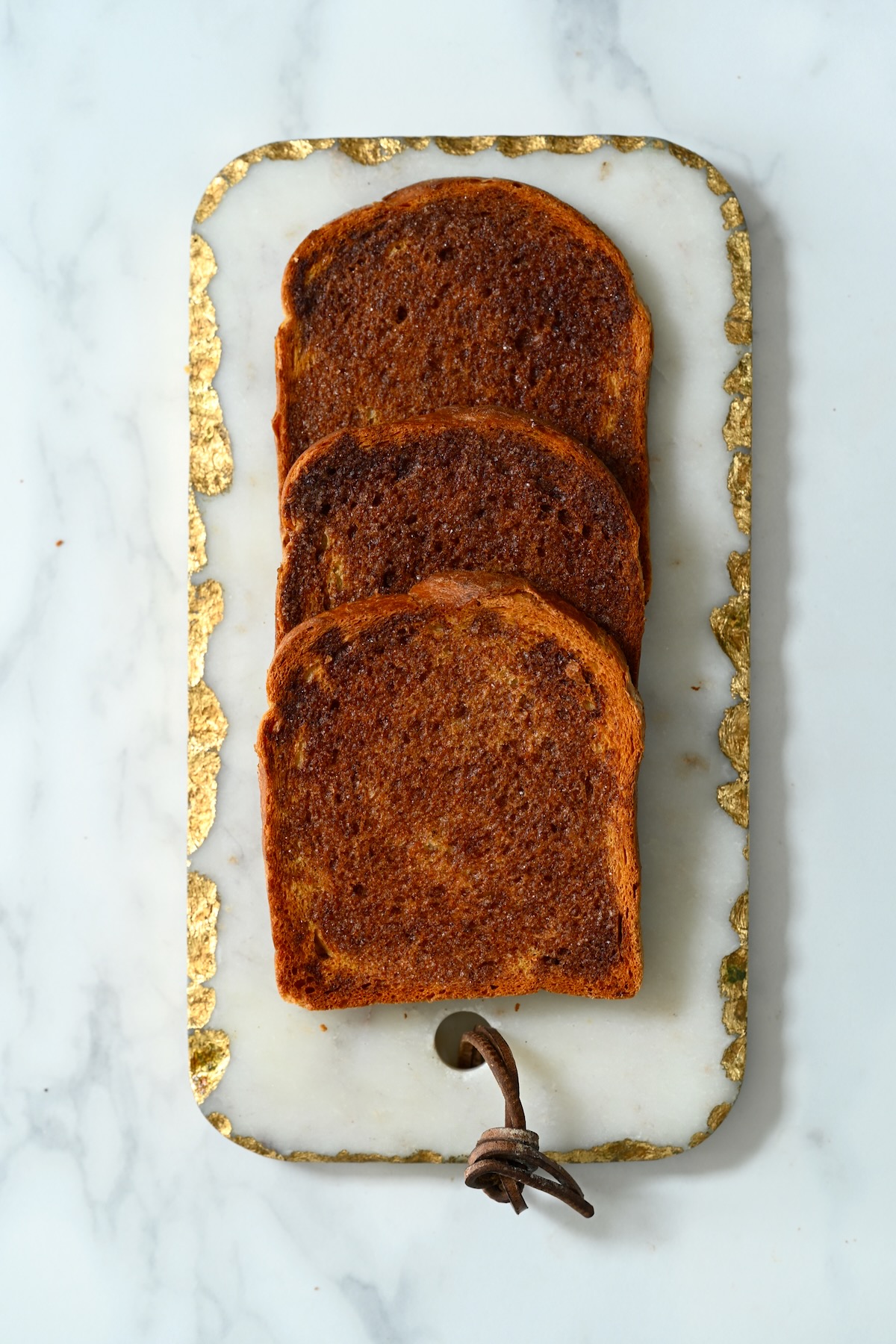 Three slices of cinnamon toast on a plate