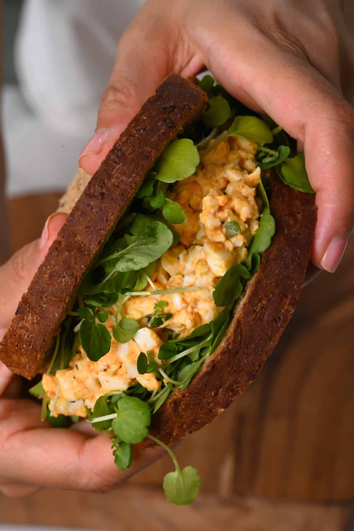 Holding an egg salad sandwich