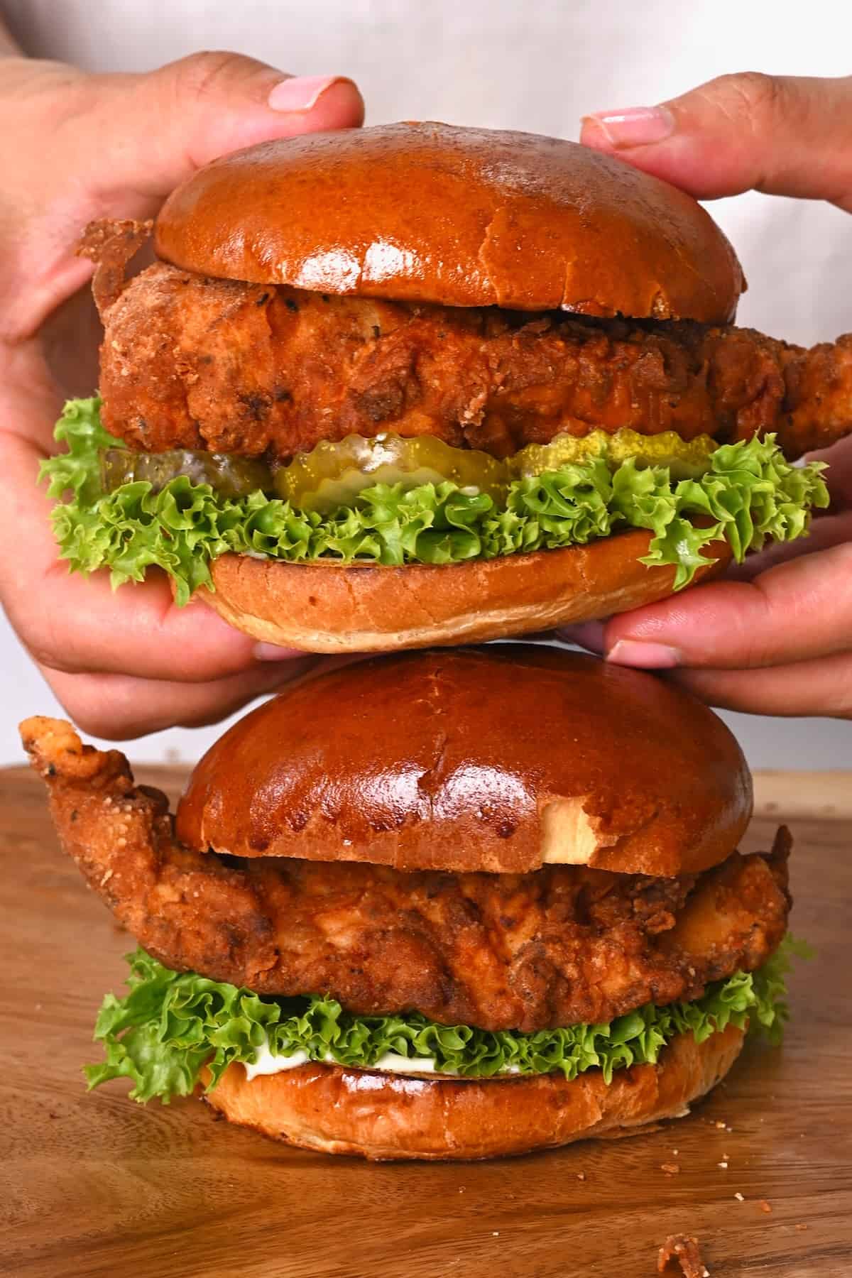 Two homemade fried chicken sandwiches with lettuce
