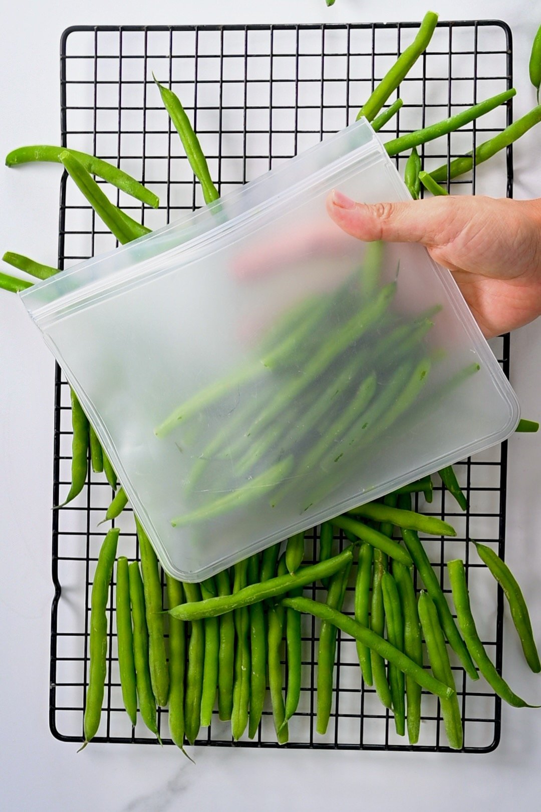 Filling a freezer bag with green beans