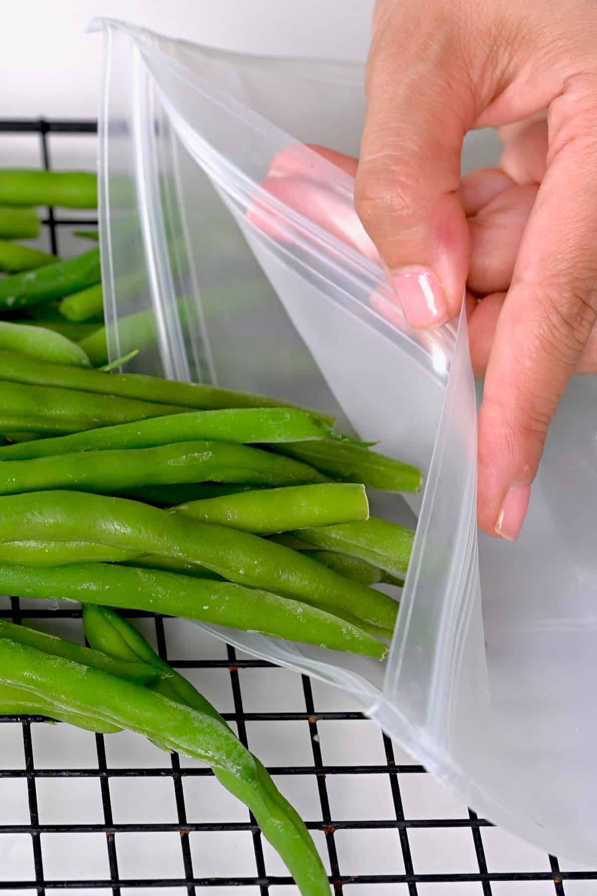 Placing green beans in a freezer bag