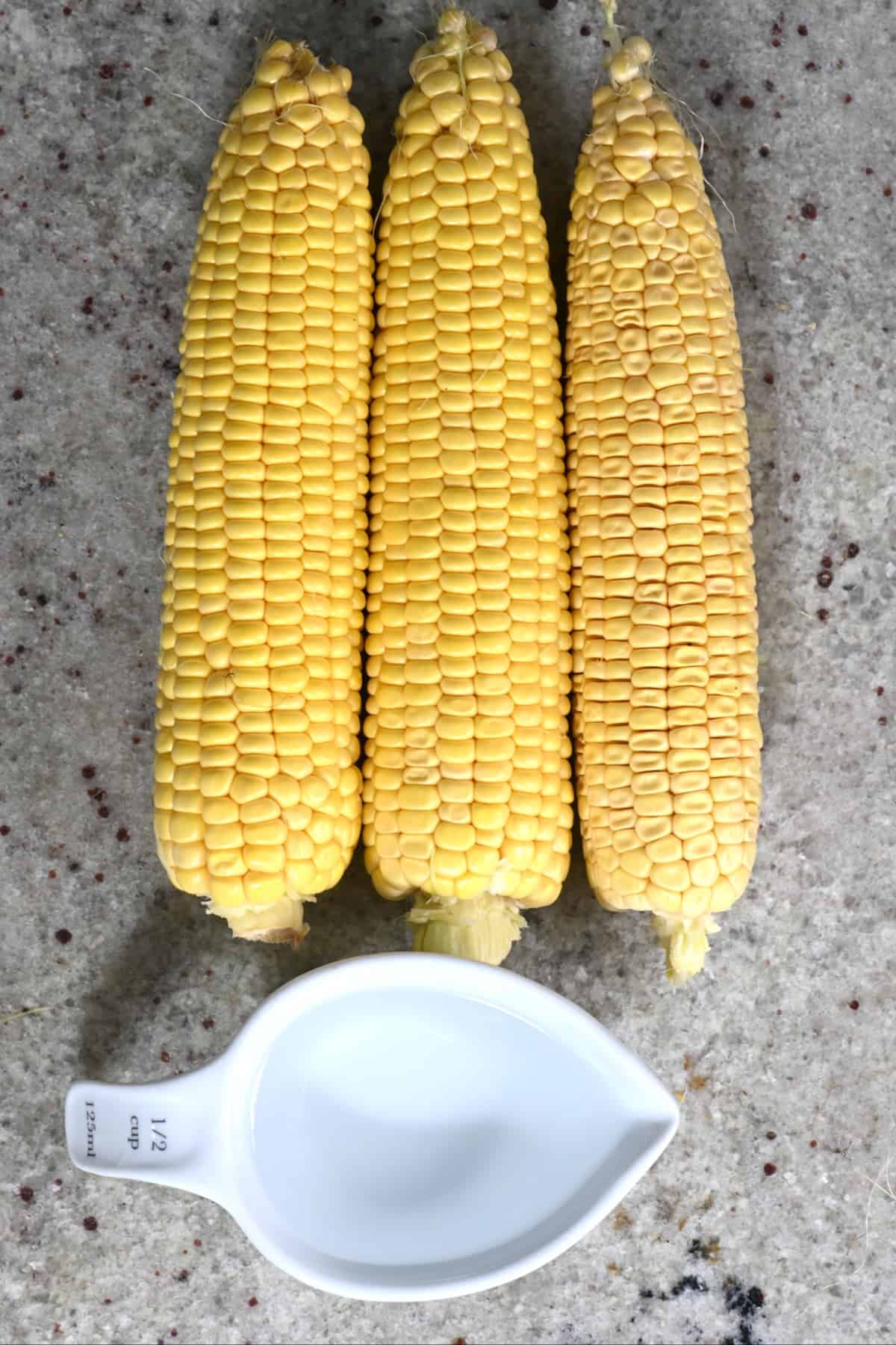 Three cobs of corn and a cup of water